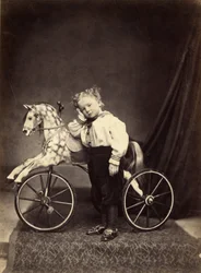 Young Boy Standing Alongside His Horse Mounted as a Tricycle, 1860s